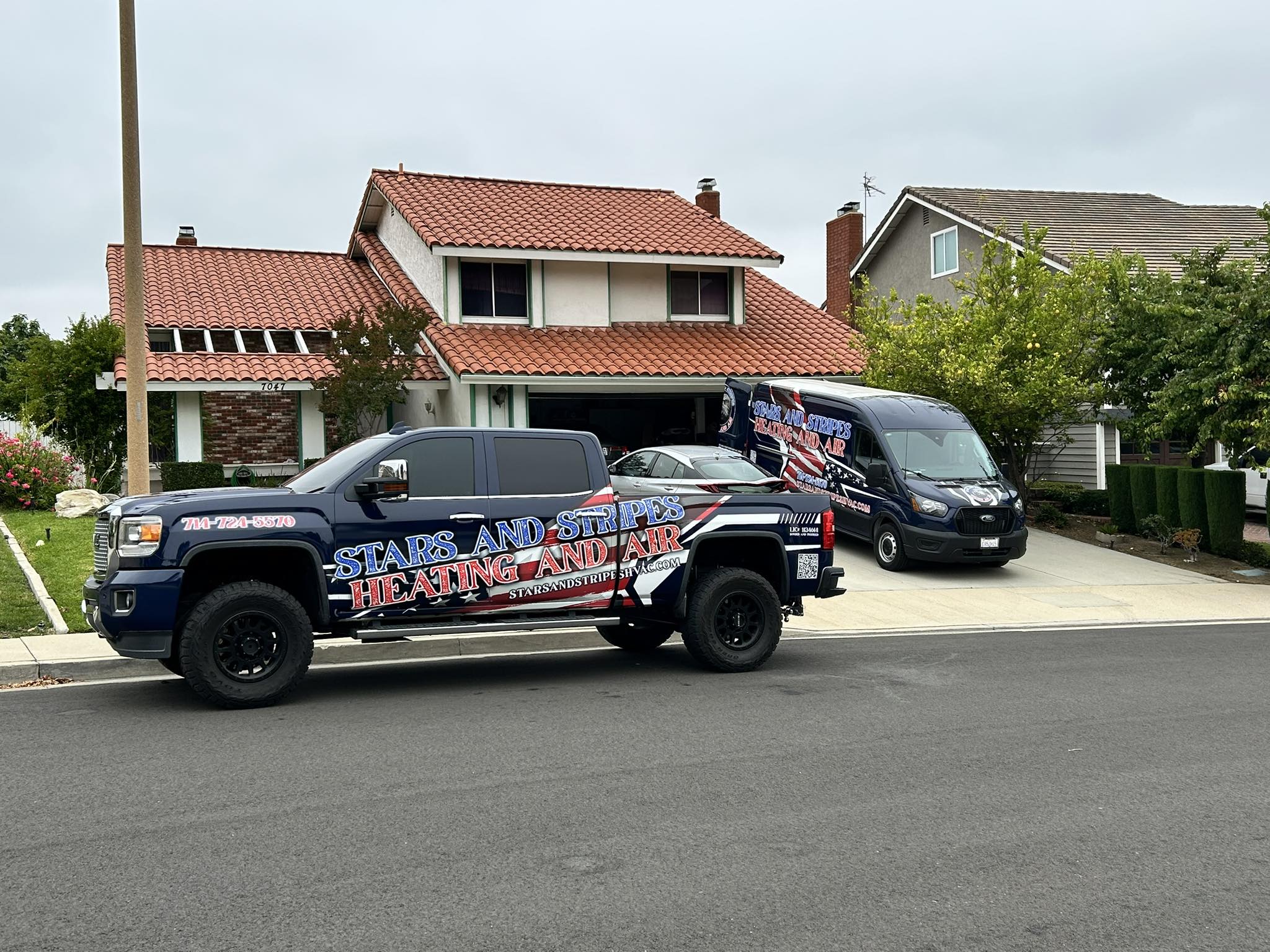 Stars and Stripes Heating and Air truck and service van at a home in Orange County